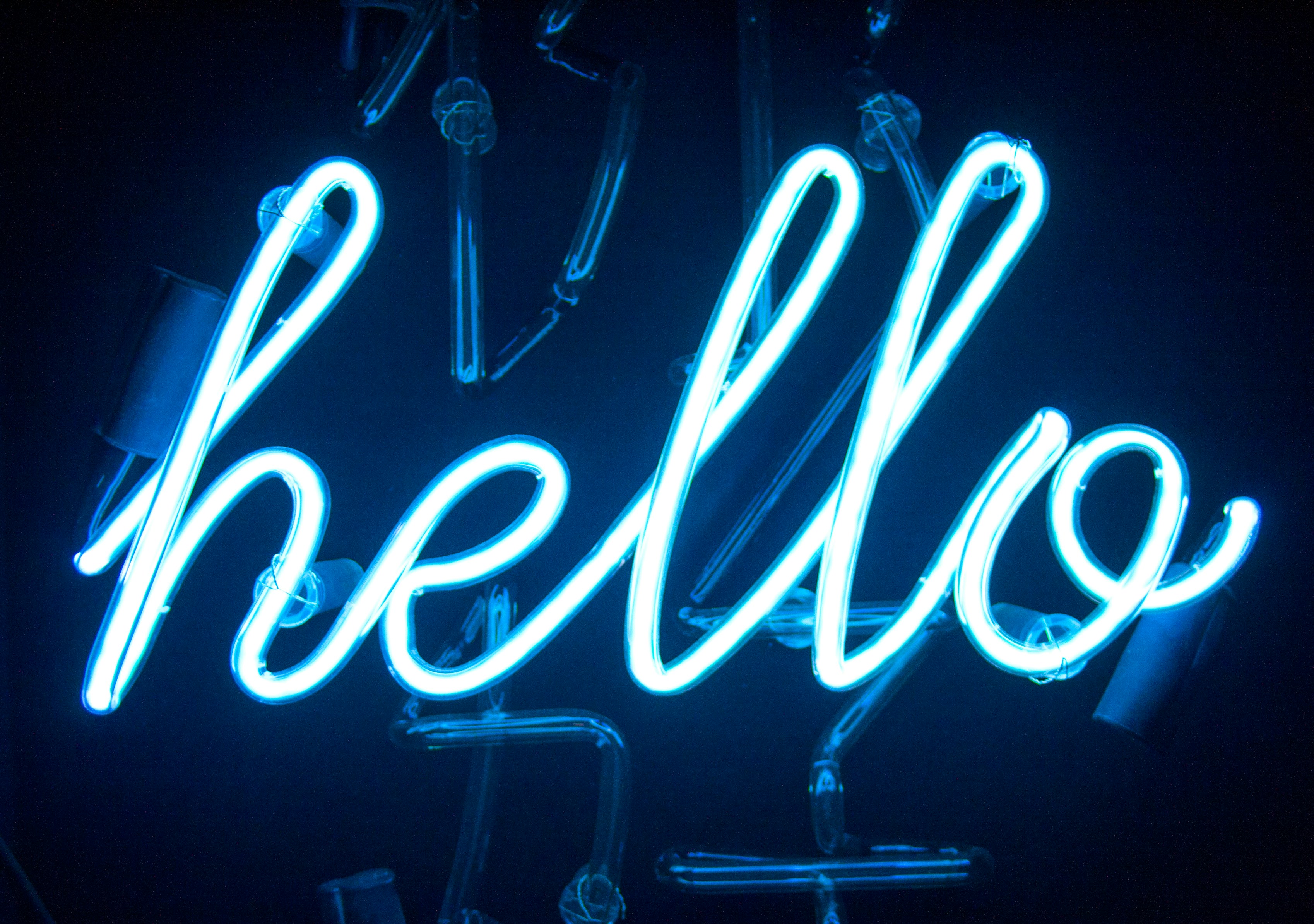 A neon sign featuring the word ‘hello’. Photo by Pablo Gentile/Unsplash