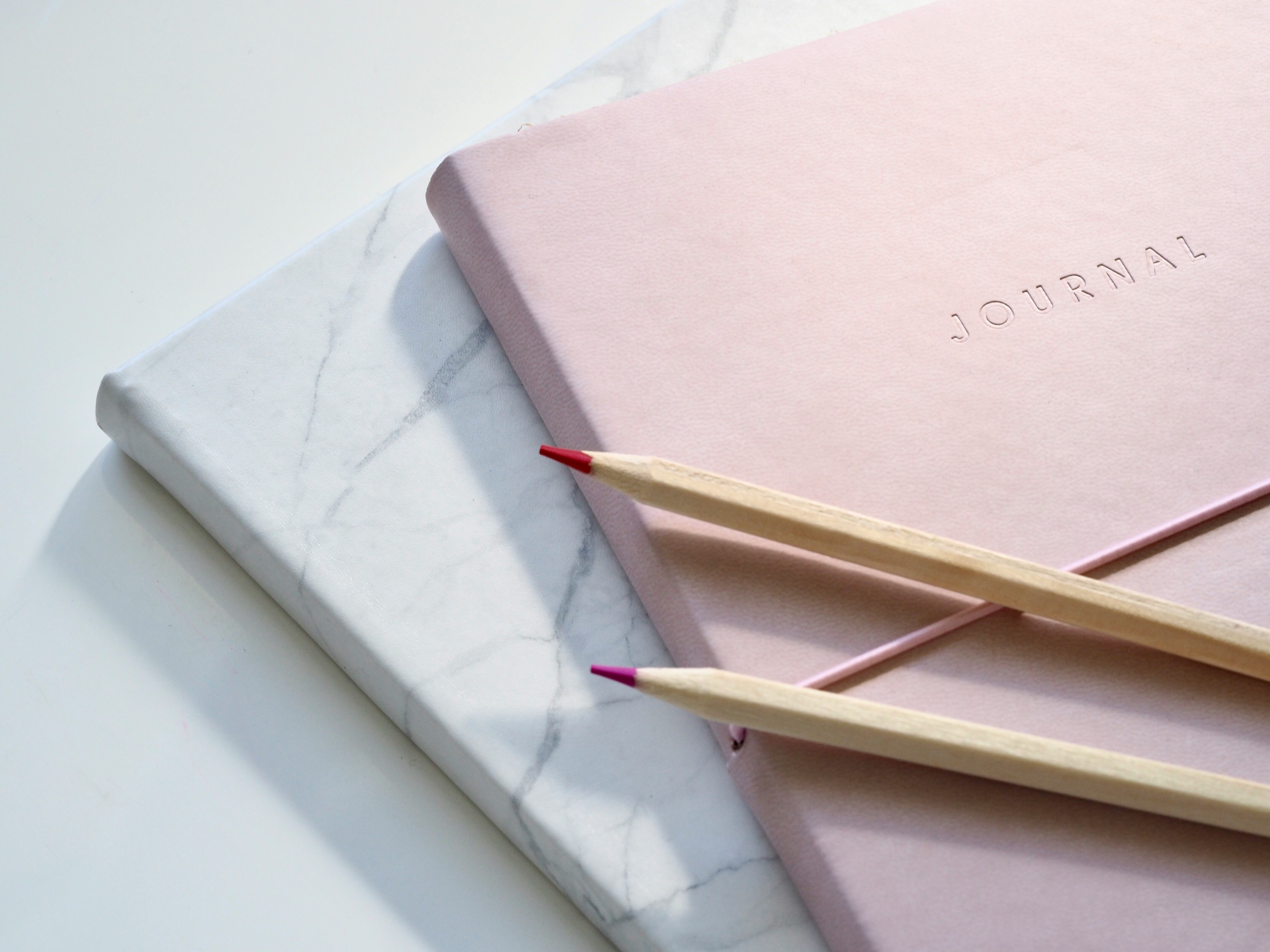 Picture of a notepad titled ‘Journal’. Photo by Jess Bailey/Unsplash